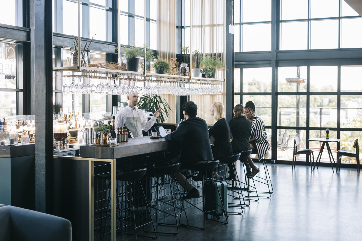 People sitting behind the bar counter