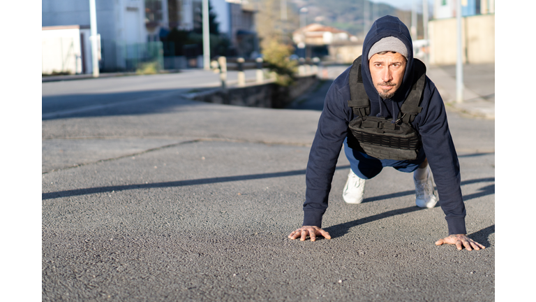 man doing sports on a sunny winter day with a weighted vest