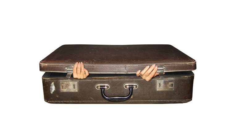 Suitcase and woman hands