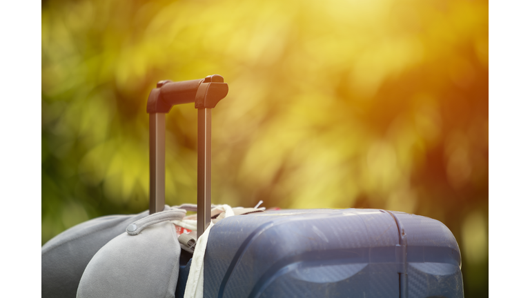 female traveler stop travel and holding mask and luggage after Covid-19(coronavirus) spread and Lock down at home