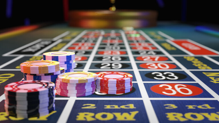 Gambling chips placed on roulette wheel table