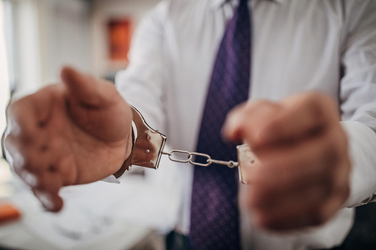Businessman arrested, handcuffed