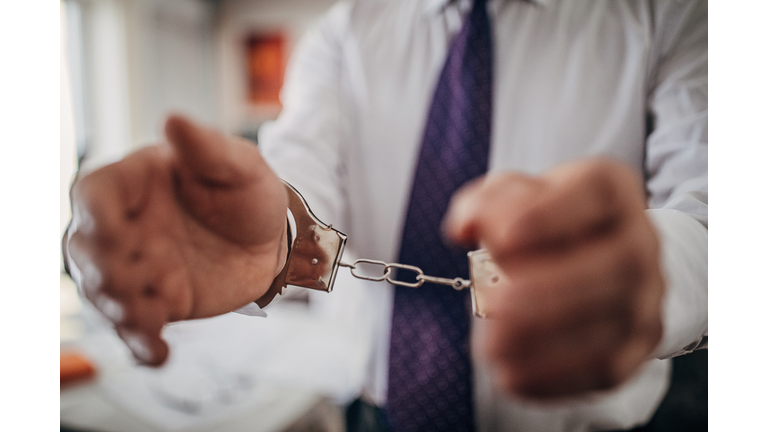 Businessman arrested, handcuffed