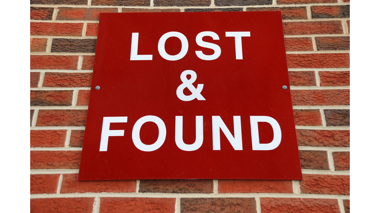 Red sign lost and found sign, nailed to a brick wall