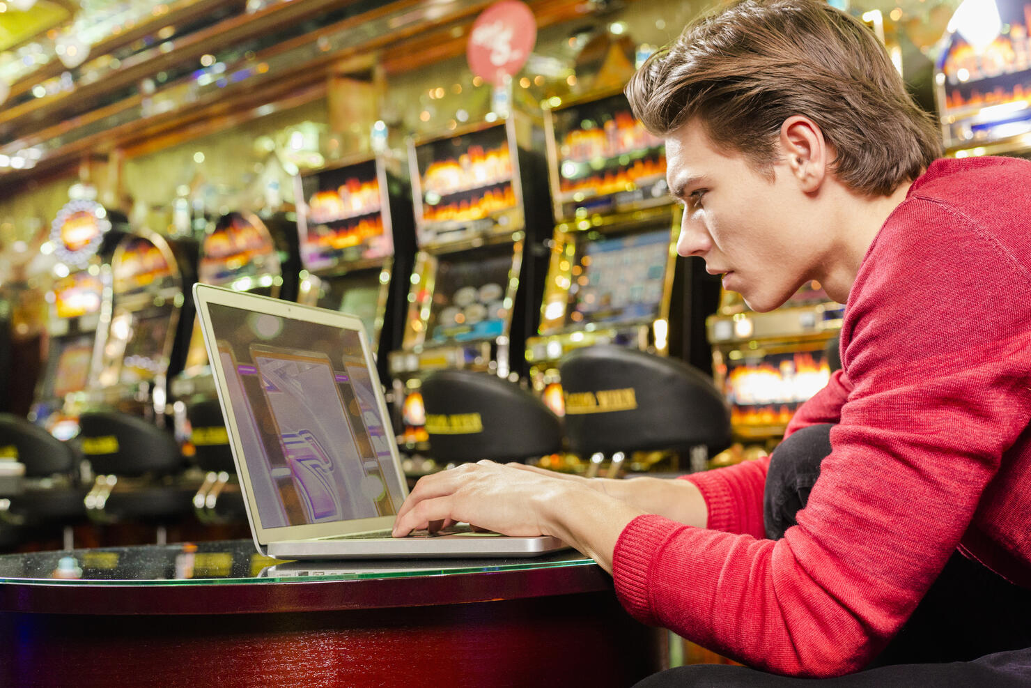 Young man playing poker on his laptop