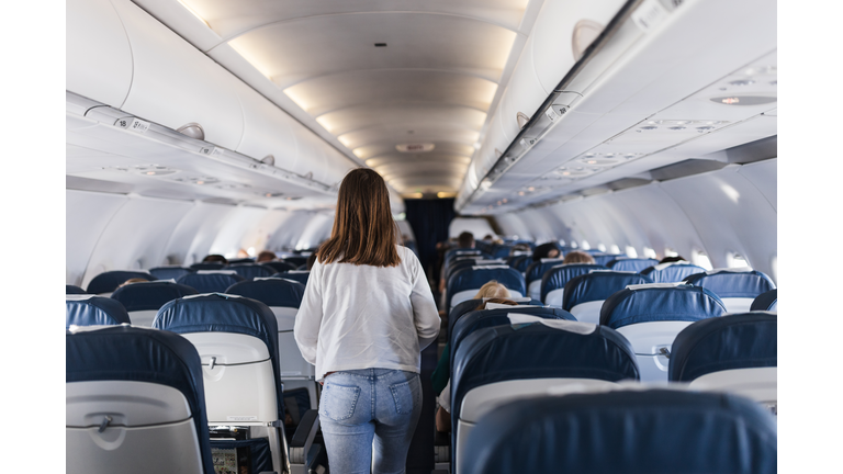 Girl leaving airplane's passenger cabin