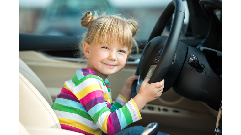 Little girl pretending to drive car