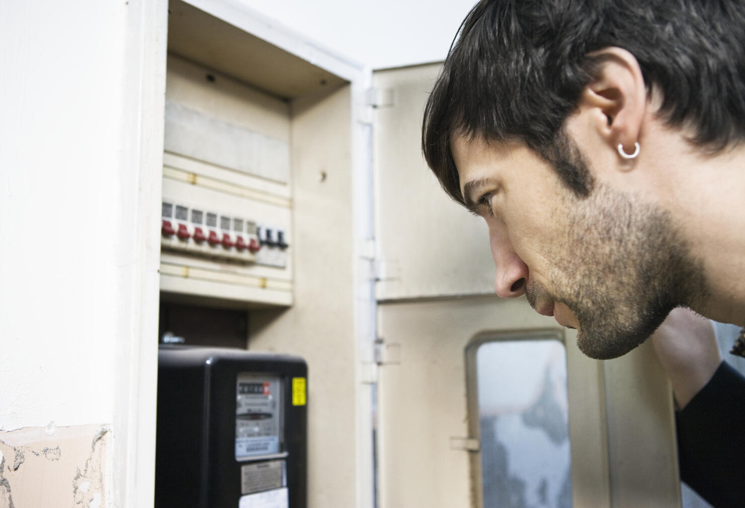 Man Looking at Utility Meter