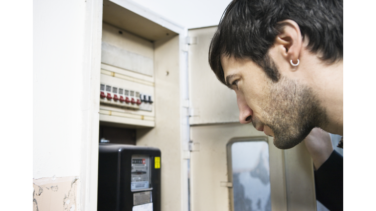 Man Looking at Utility Meter