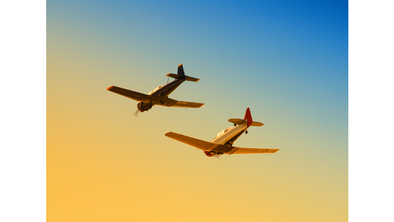 Two planes flying together in the sky