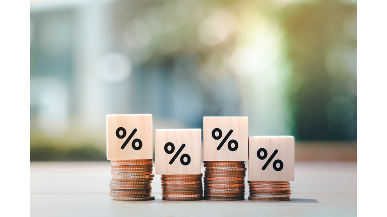 Interest rate finance and mortgage rates. Wooden block with percentage sign on many level of stack of coin. Financial growth, interest rate increase, inflation, sale price and tax rise concept.