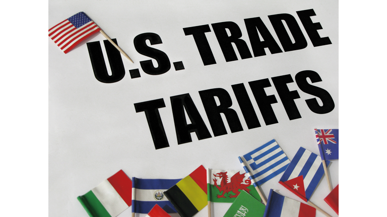 Words "U.S. TRADE TARIFFS" with U.S. FLAG and some FLAGS from AROUND THE WORLD.