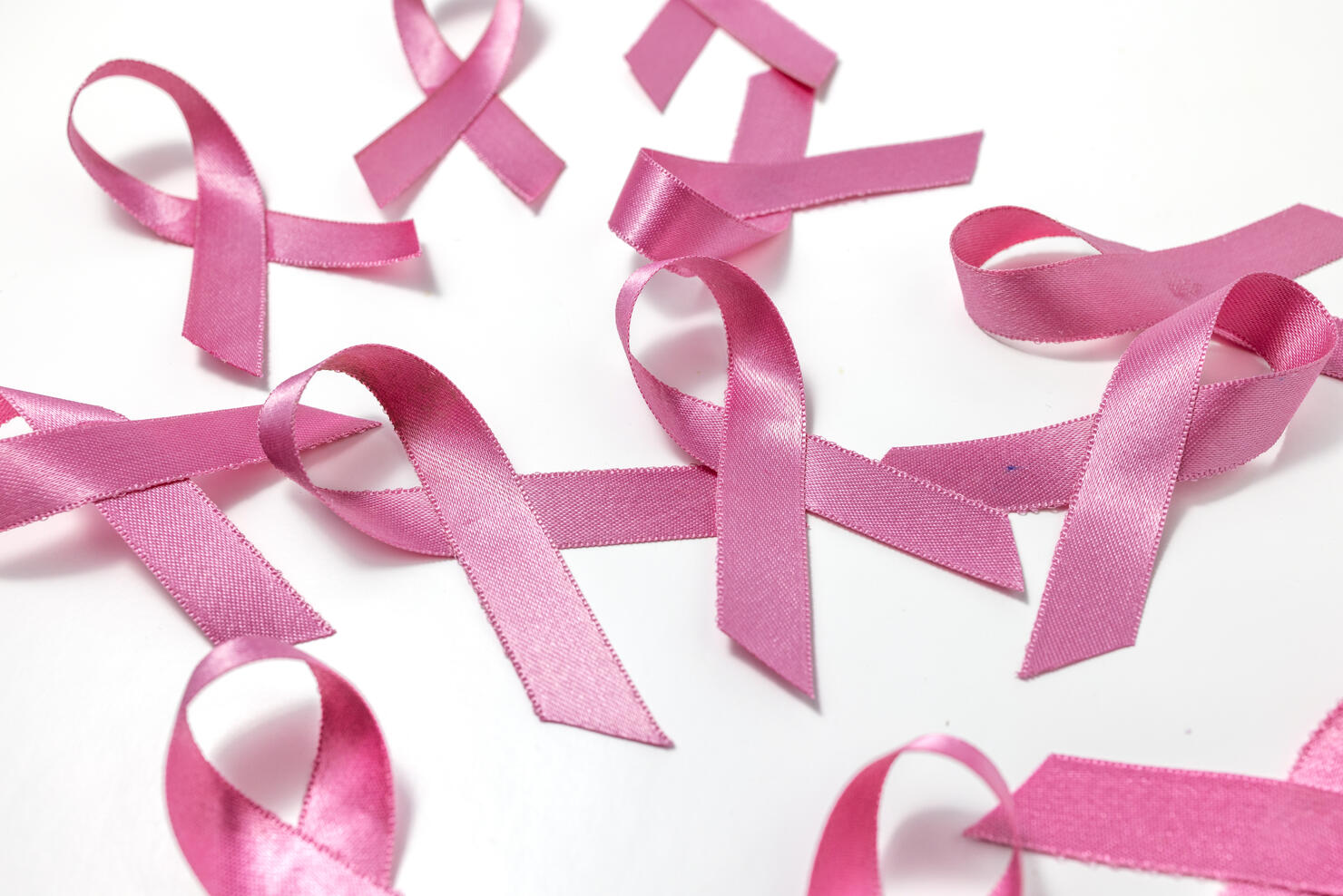 Cancer ribbons randomly placed on white background.