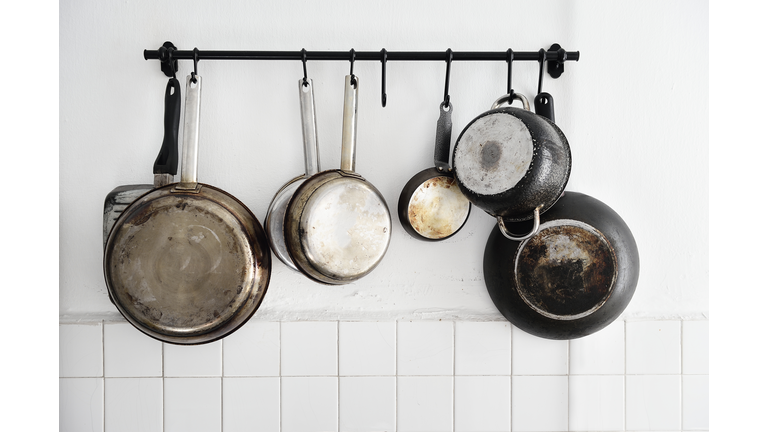 Pots and pans hanging on a kitchen wall