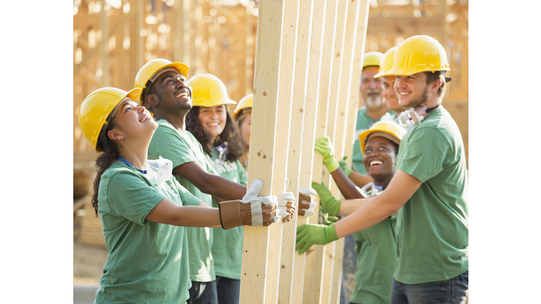 Volunteers holding wood frame together