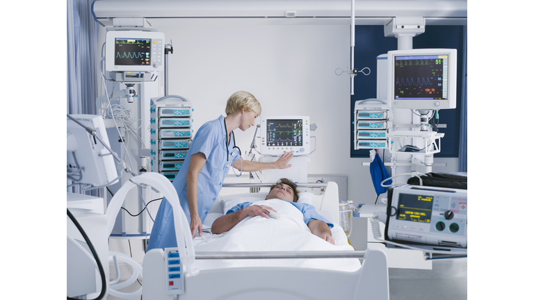 Nurse tending patient in intensive care