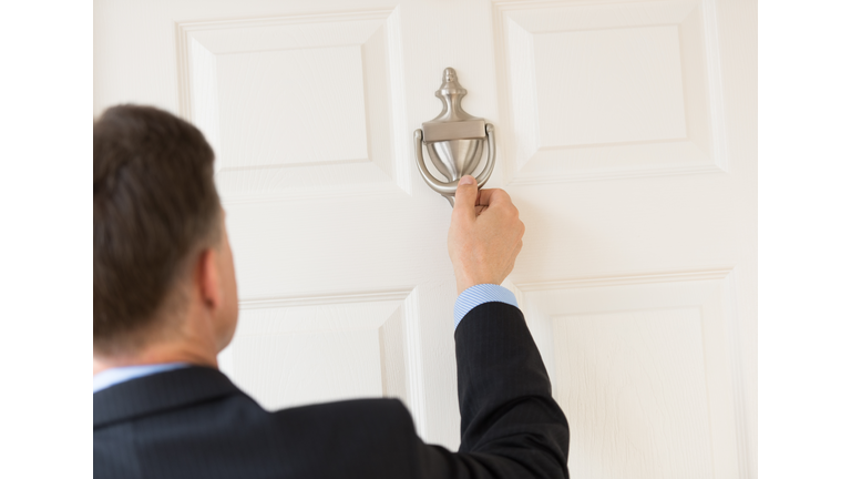 Businessman Knocking Door Knocker