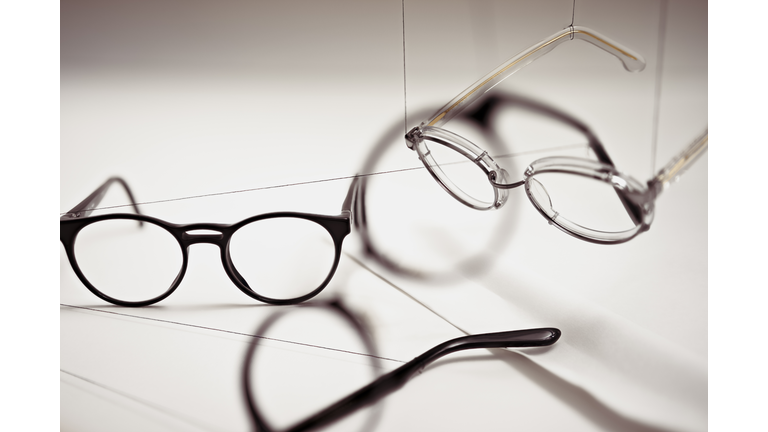 Groups of reading glasses hanging and suspended