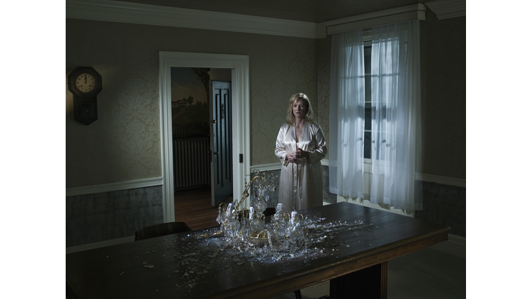 woman looking at fallen chandelier