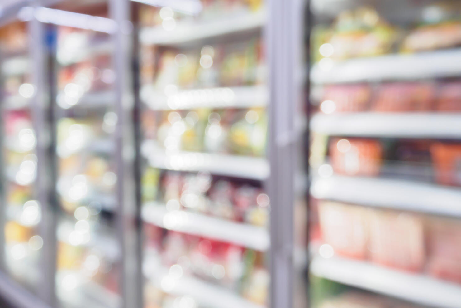 Refrigerator shelves in the supermarket blurred background