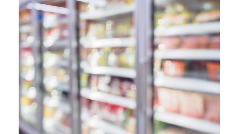 Refrigerator shelves in the supermarket blurred background