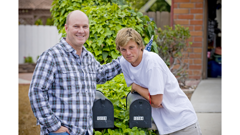 father/son portrait, leaning on mailboxes