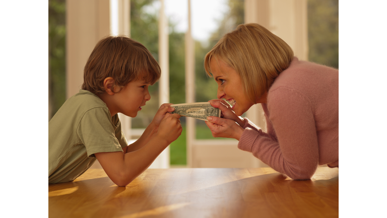 Mother and son hold paper currency