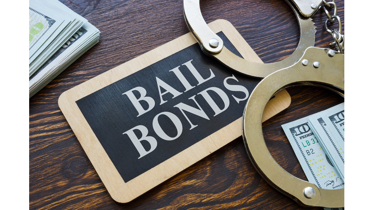 Plate Bail bonds and handcuffs on it.