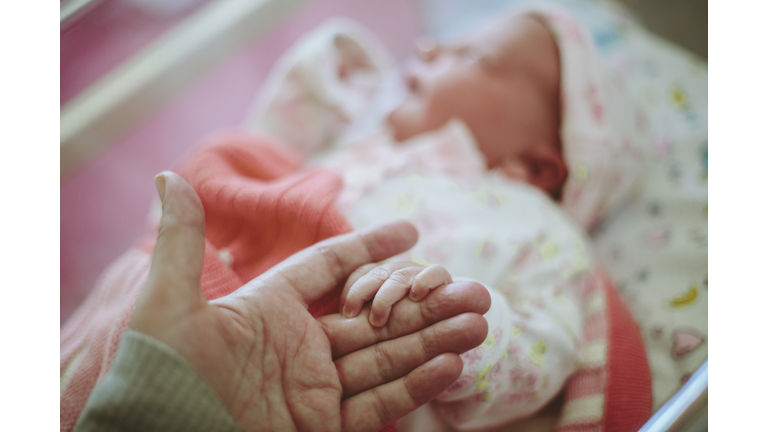 Newborn baby holding Mothers hand