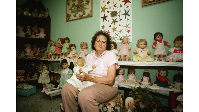 Elderly Woman with Doll Collection