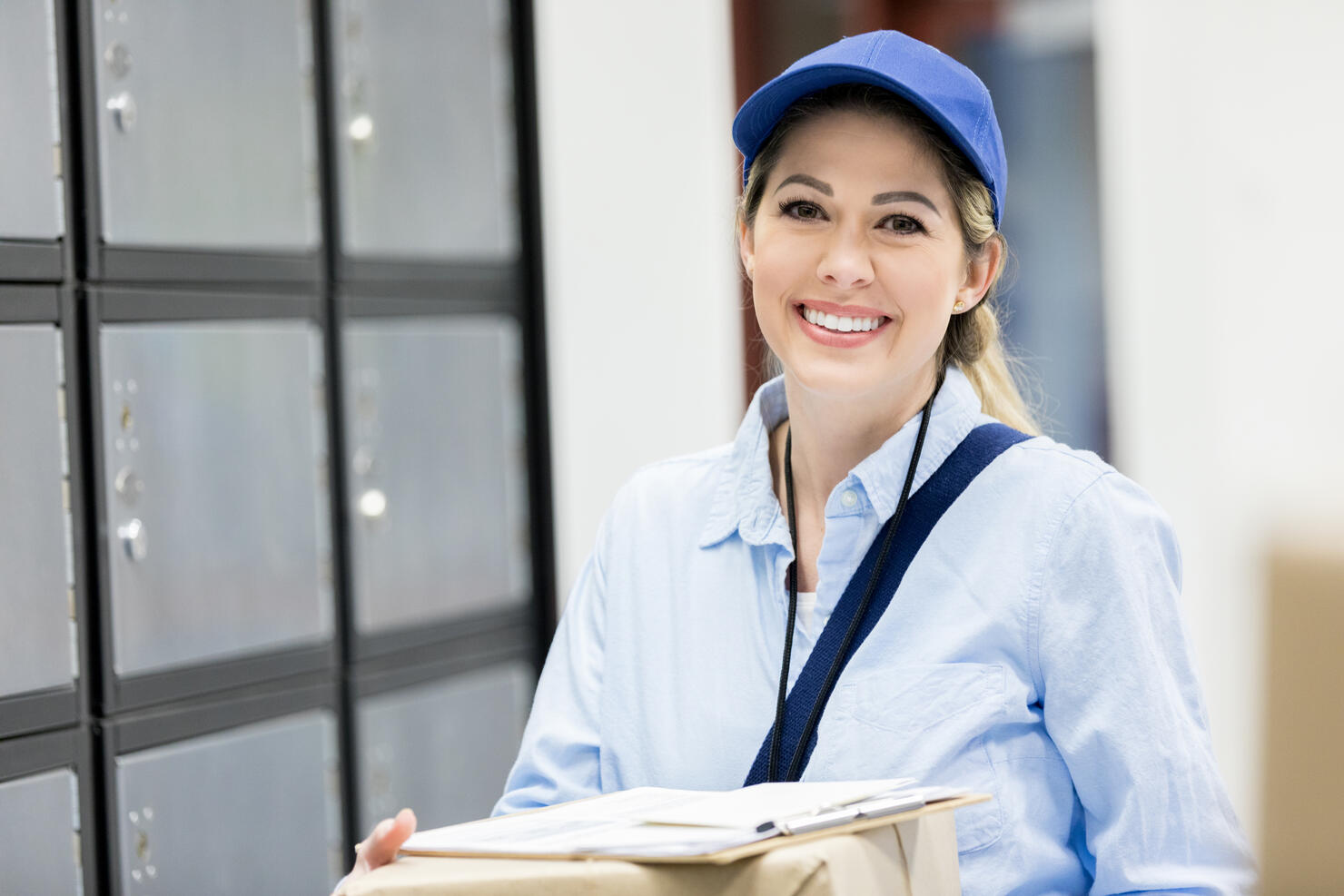 Smiling female mail carrier at work