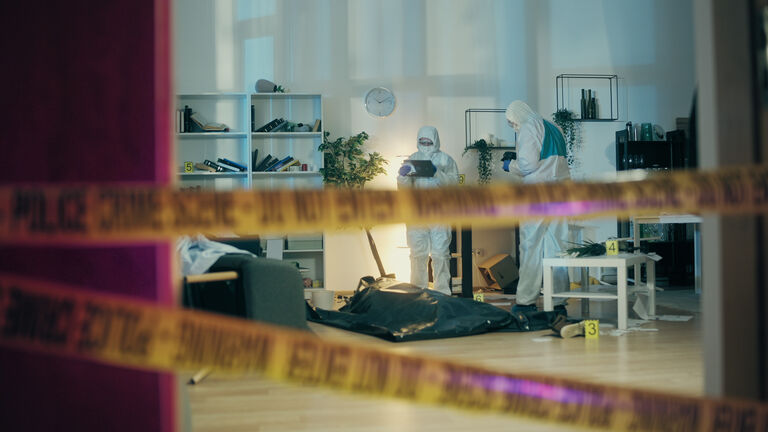 Forensic experts are taking photos of the crime scene as part of the evidence collection process for the murder investigation