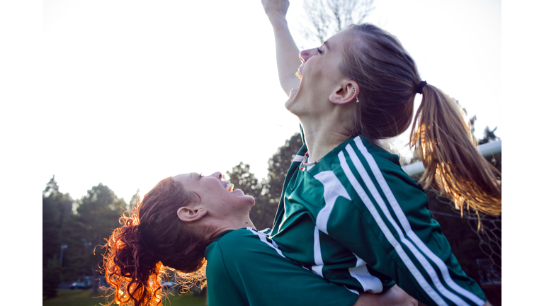 Two female friends cheering