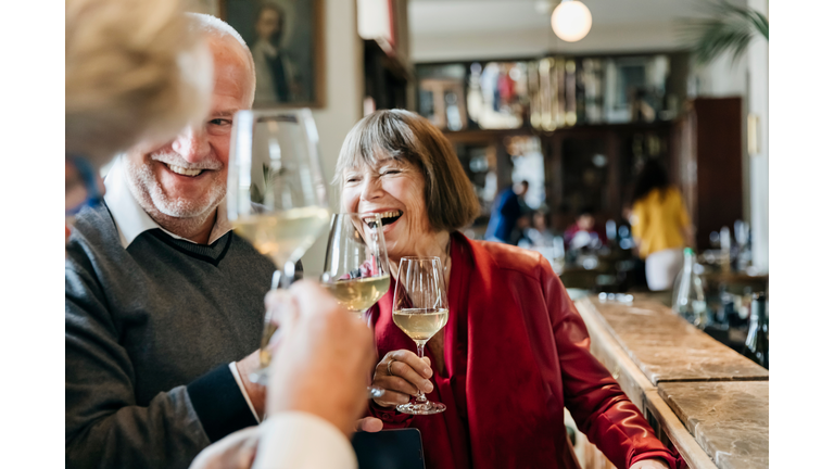 Group Of Mature Friends Having Fun At Restaurant Bar