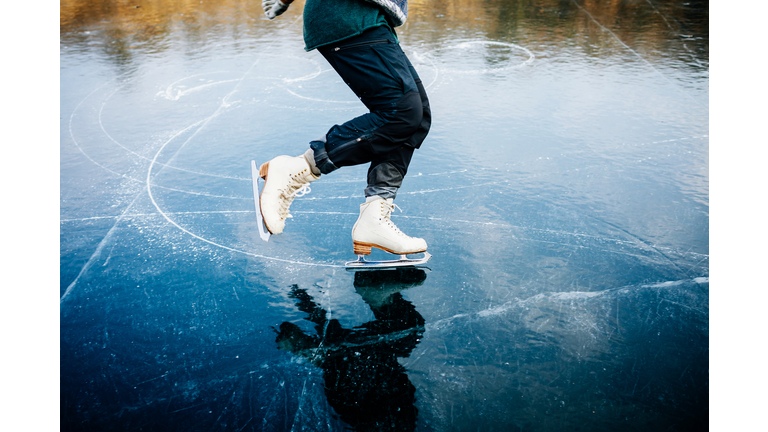 Ice Skater Blades Cutting Curves Into Frozen Lake