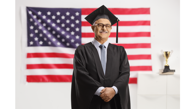 University dean standing in front of USA flag