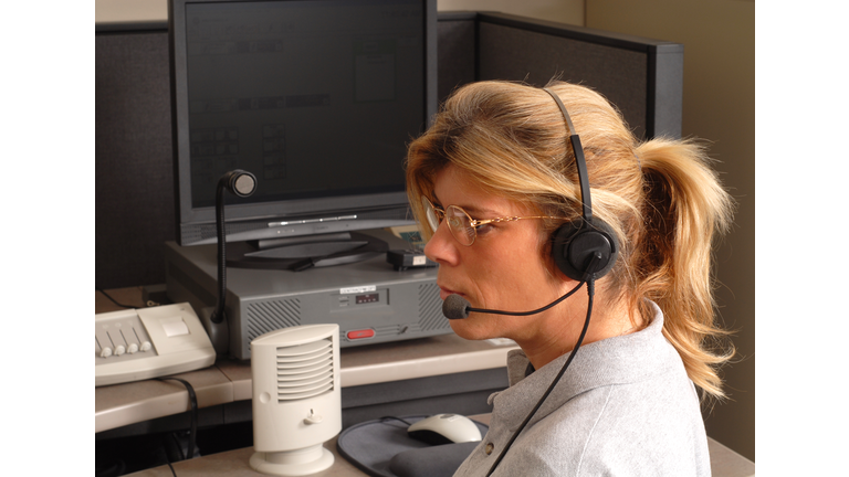 Police dispatcher sitting at a dispatch console