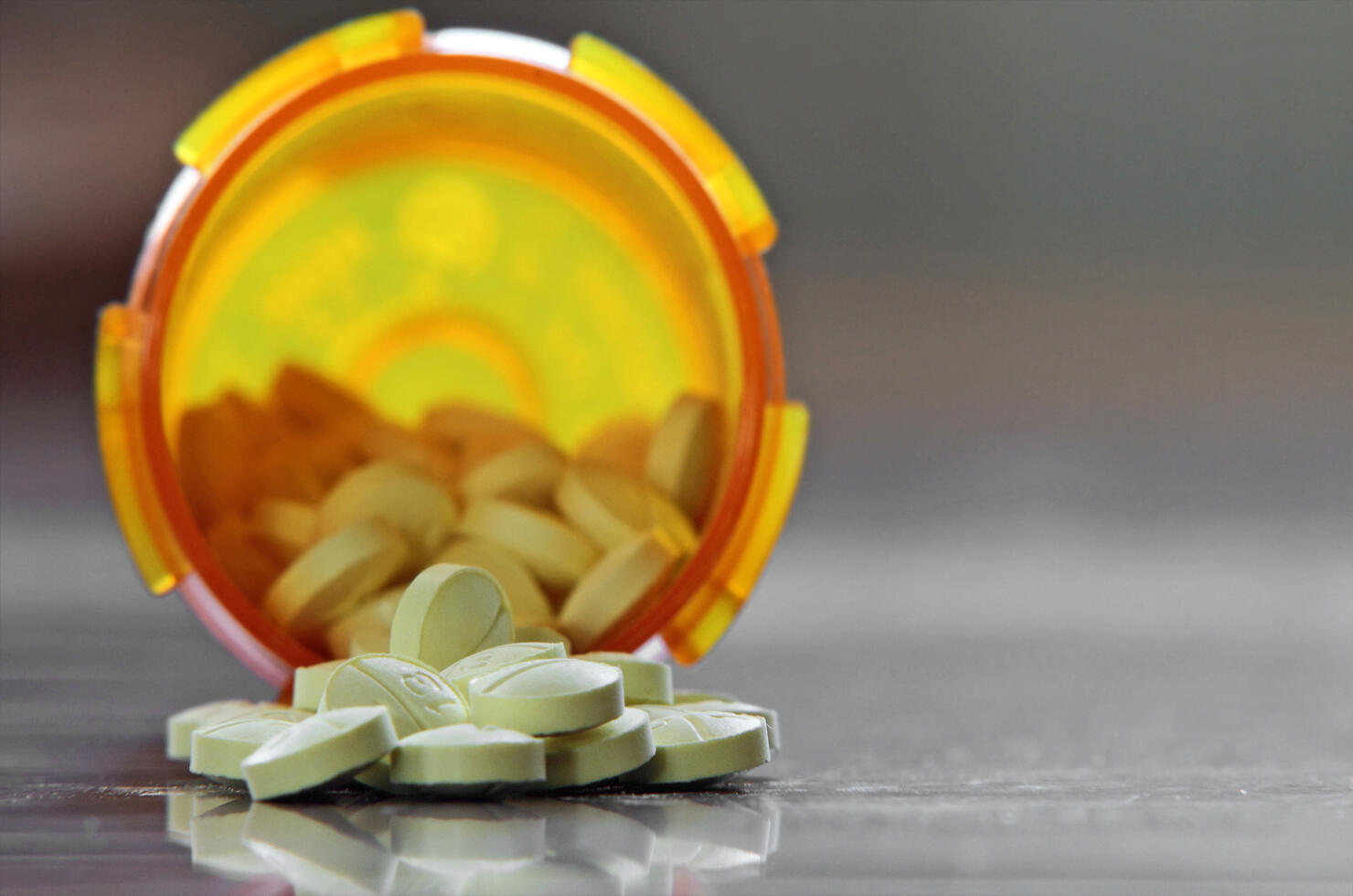 Bottle of pills with pills spilling out