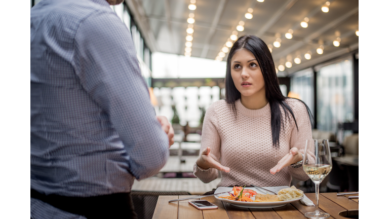 Portrait of woman complaining about food quality in restaurant.