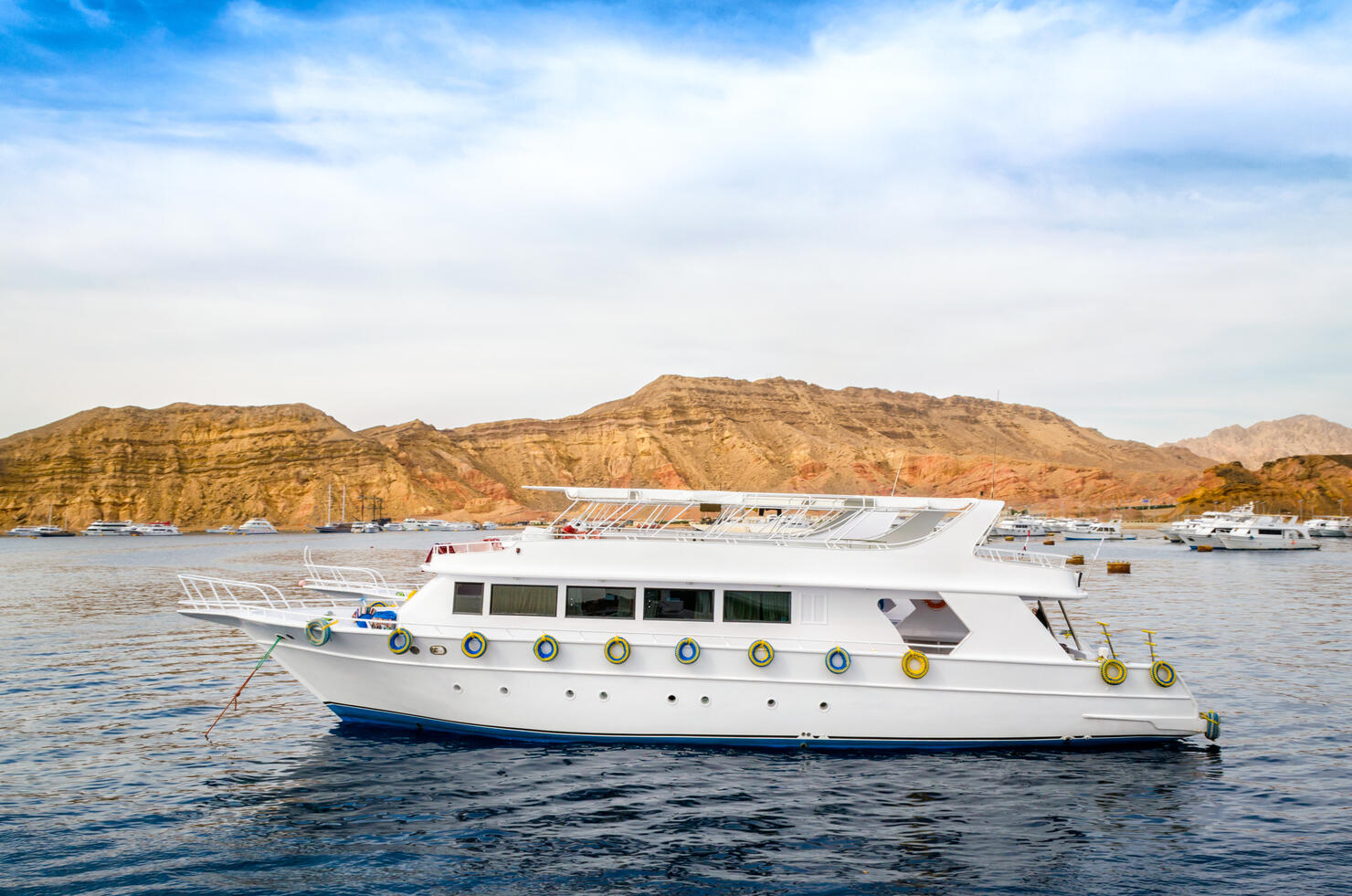 cruise tourist white boat in the Red Sea off the rocky coast in Egypt