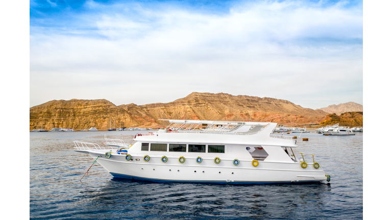 cruise tourist white boat in the Red Sea off the rocky coast in Egypt