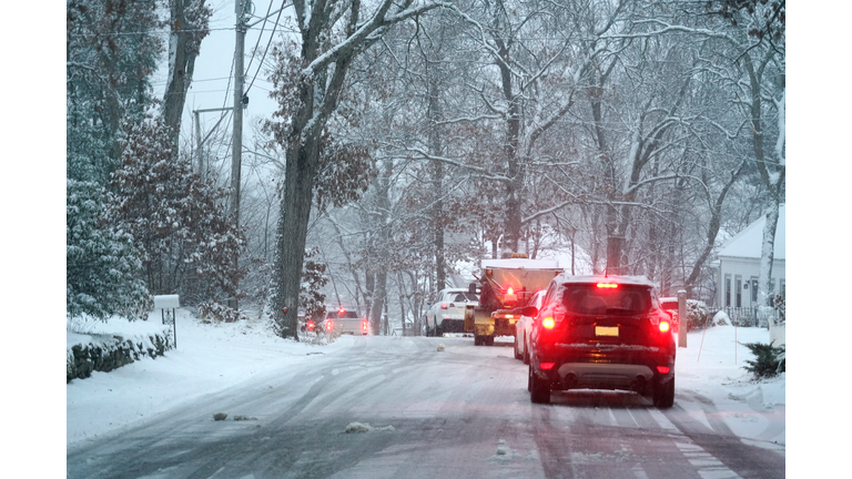 Vehicles stopping on the road after snow in residential area