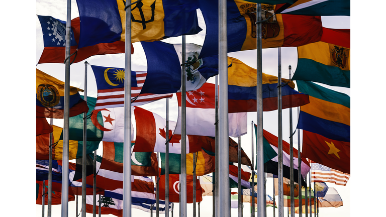 Flags of different nations on high flagpoles