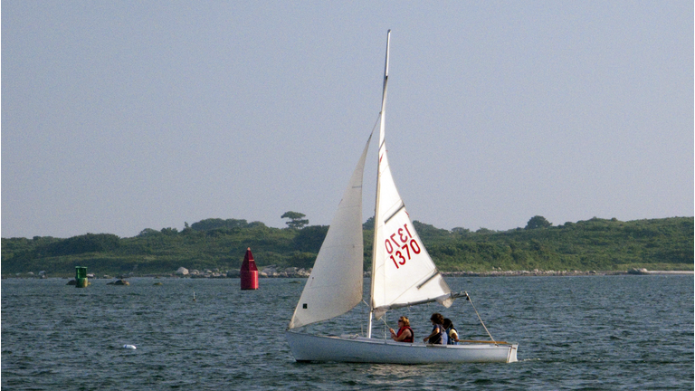 A group of sailors on a boat in the wate