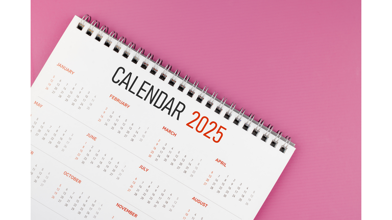 2025 desk calendar on pink color background, Position with copy space.