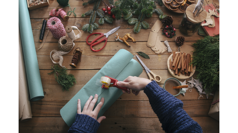 Woman's hands wrapping christmas gifts