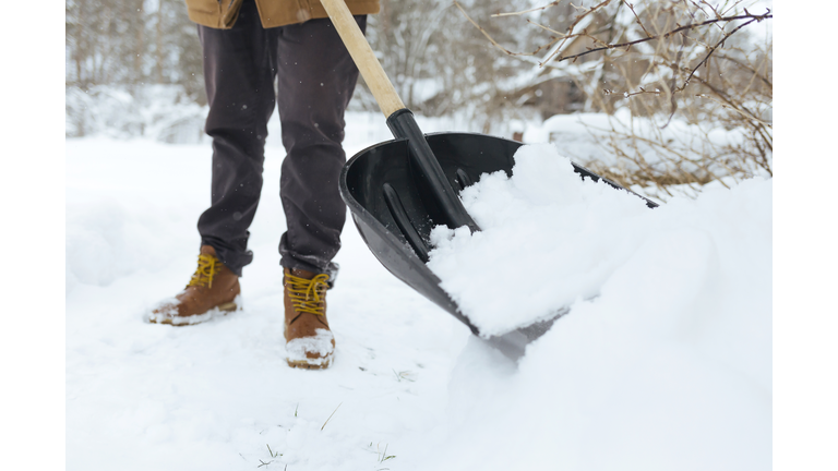 Crop view of man shoveling snow