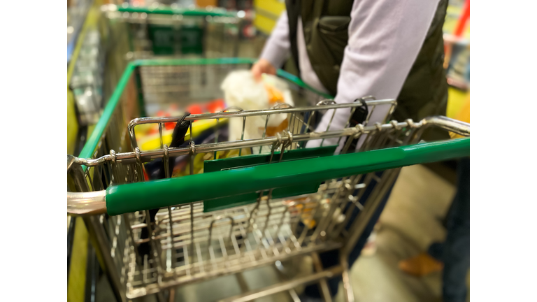 dad unloading groceries at checkout counter for purchase