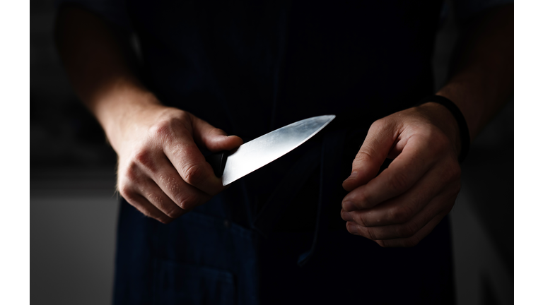 Dangerous Man Holds Sharp Knife In Darkness