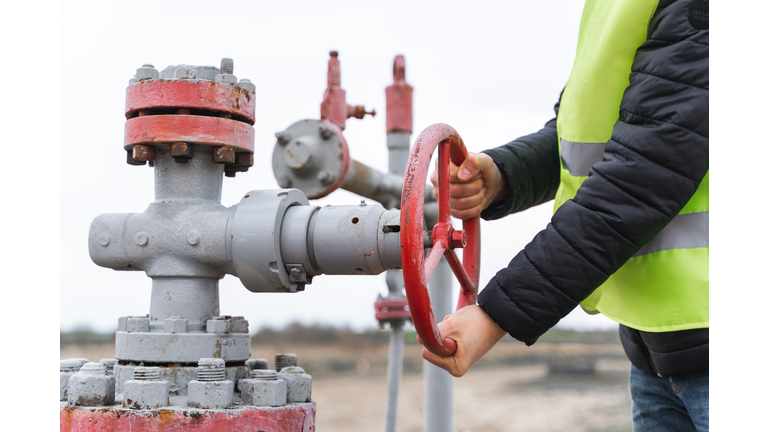 Stationary or technical unrecognizable engineer turning on off vent of gas pump